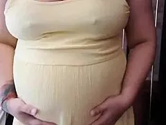 Pregnant wife touching herself with deep longing