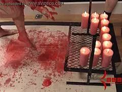 The redhead babe endures hot wax in bondage.