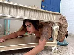 Stepmom gets stuck and fucked under the table by her horny stepson.