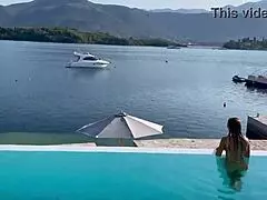 Monika Fox swims naked in the pool, her big tits exposed