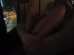 Petite babe masturbates openly by hotel window for all to see.