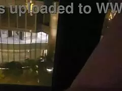 Petite babe masturbates openly by hotel window for all to see.