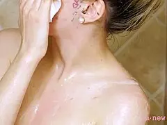 gorgeous blonde takes a relaxing shower on the sofa