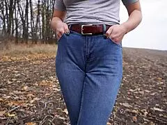 Milf teasing her big cameltoe in blue jeans outdoors