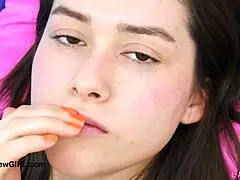 alluring brunette beauty reveals her stunning figure on the sofa