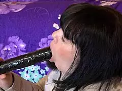 Milf sucks big dildo in fur-trimmed coat