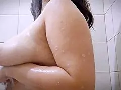 Solo pinay with big natural tits - took a shower. She bathes under the water, showing off her huge boobs and nipples.