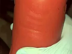 Stocking-clad person deep throats a toy intensely.