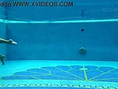 In the pool, a Hungarian woman plays naked sazan cheharda, swimming and teasing underwater with playful moves.