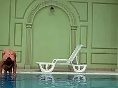 In the pool, a Hungarian woman plays naked sazan cheharda, swimming and teasing underwater with playful moves.