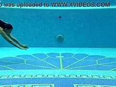 In the pool, a Hungarian woman plays naked sazan cheharda, swimming and teasing underwater with playful moves.