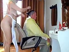 Nude hairdresser in apron surprises client at nudist barbershop!