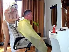 Nude hairdresser in apron surprises client at nudist barbershop!