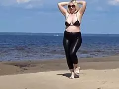 big leather ass strolls along the sandy beach in nature