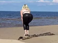 big leather ass strolls along the sandy beach in nature