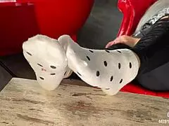 Goddess teases wrinkled feet in socks and barefoot under desk