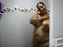 The cute Colombian BBW with huge natural tits gets bent over in the shower, her tight pussy squirting