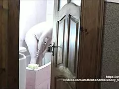 Naked blonde in bathroom, roommate watches and cums on her wet pussy?