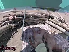 two exhibitionist wives give amateur milf handjob to big cock on nude beach in front of voyeur with cumshot