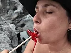 a stepmom practices sucking candy on beach then sucks stepsons dick