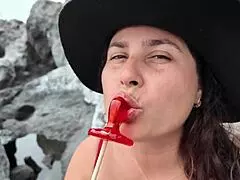 a stepmom practices sucking candy on beach then sucks stepsons dick