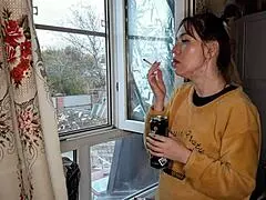 The stepsister lights up a cigarette in a quiet moment