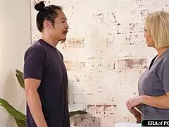 milf masseuse strokes asian guy's cock with her feet during nuru session