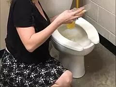 Pretty babe shows off her ass while peeing in the bathroom