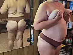 MILF STRIPS DOWN SHOWING OFF HER HUGE ASS AND MASSIVE TITS FOR YOU!!