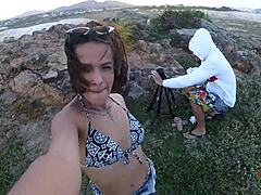 Young girl blows rocks by sea