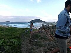 Young girl blows rocks by sea